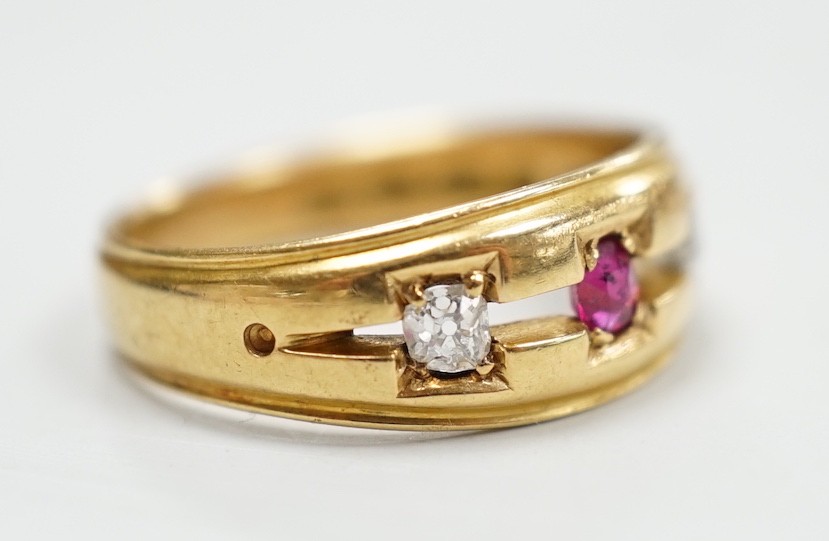 A late Victorian 18ct gold, ruby and diamond set three stone ring, size K/L, gross weight 4 grams.